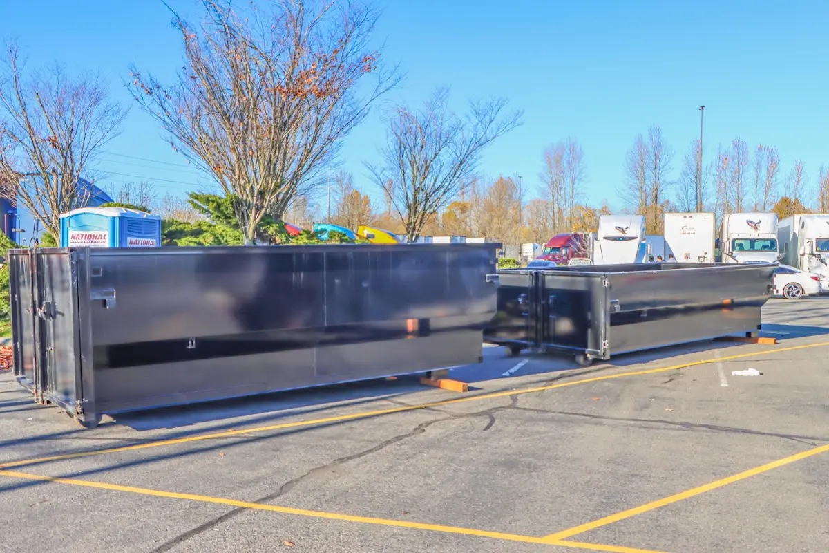 Professional dumpster rental service with roll-off container on residential driveway in Brookville